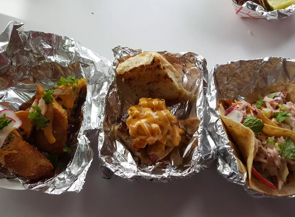 A trio of deliciousness!! Our Thai style chicken eggroll, Portuguese slider, and Fish Tacos