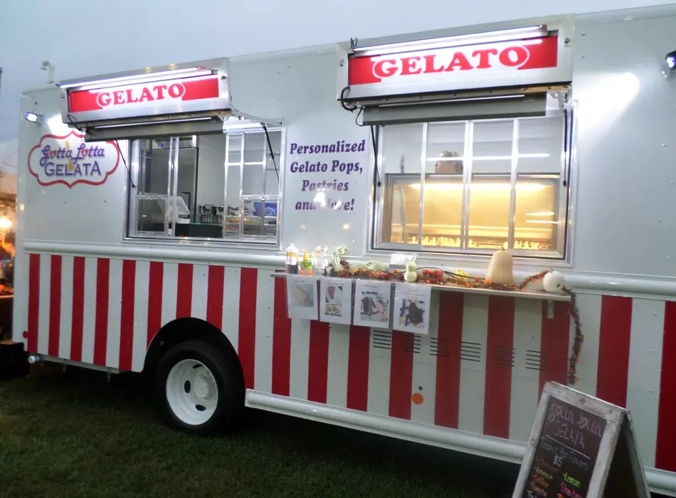 Side view of the Gotta Lotta Gelato food truck lit up at night