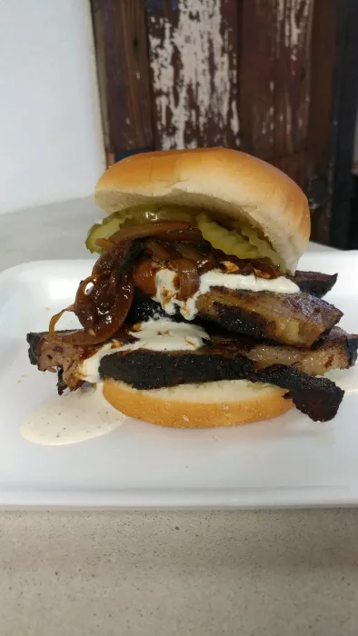 Smoked Brisket Sandwich + BBQ Caramelized Onions + Horseradish Cream + Saw's Sauce + Pickles