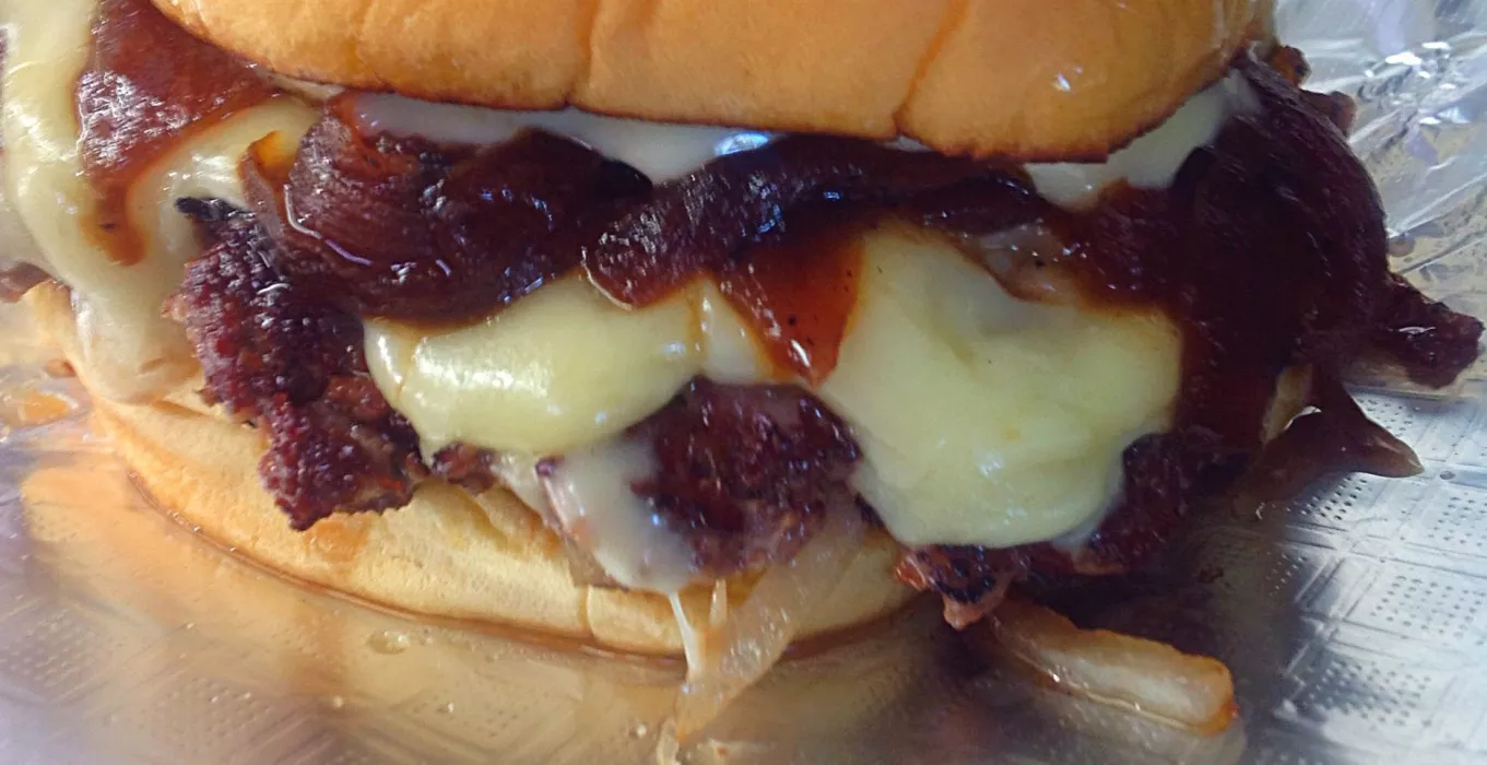 Parisienne Burger: Seared Black Angus Beef, Caramelized Onion, Gruyere Cheese, Roasted Garlic Aioli